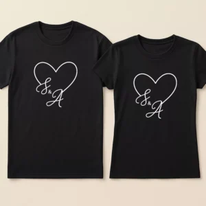 Matching Couple T-Shirts 21 Matching black custom initial couple t shirts featuring a white heart outline and personalized calligraphy letters S and A.