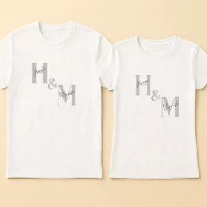 Matching Couple T-Shirts 23 A happy couple wearing matching black personalized initial couple t shirts with white typography and an ampersand symbol.