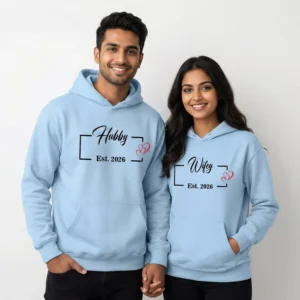 Couple wearing custom Hubby Wifey hoodies with personalized wedding year, matching blue sweatshirts by Divine Bonds