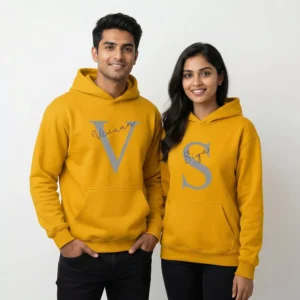 Couple wearing yellow personalized initial hoodies with custom names