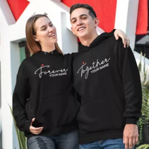 Couple wearing black personalised “Forever Together” matching hoodies with custom name print, ideal for anniversary or romantic gifts.