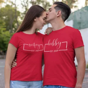 Couple wearing personalised hubby and wifey matching red t-shirts with names, romantic matching couple outfit for pre-wedding or anniversary.