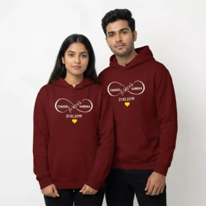 Couple wearing personalized infinity hoodies with custom names and anniversary date design